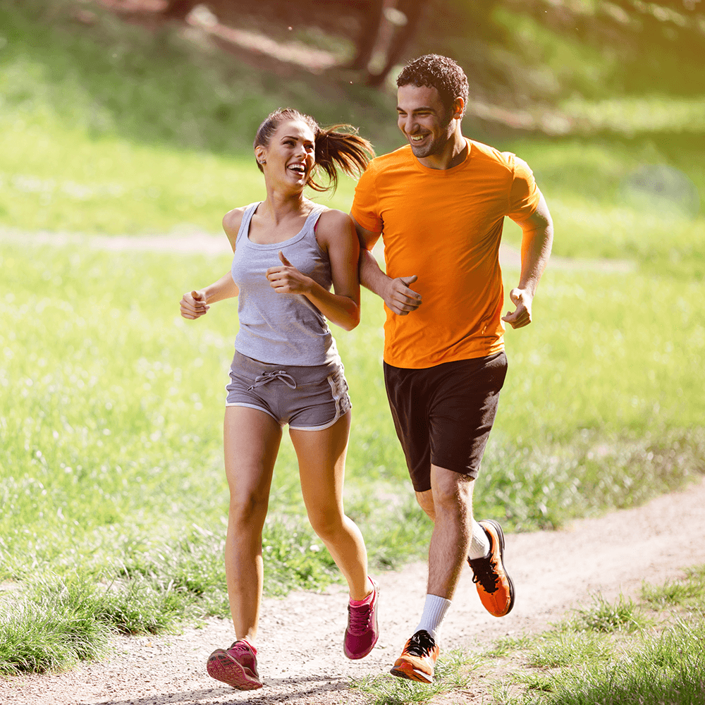 Man and woman smiling and running