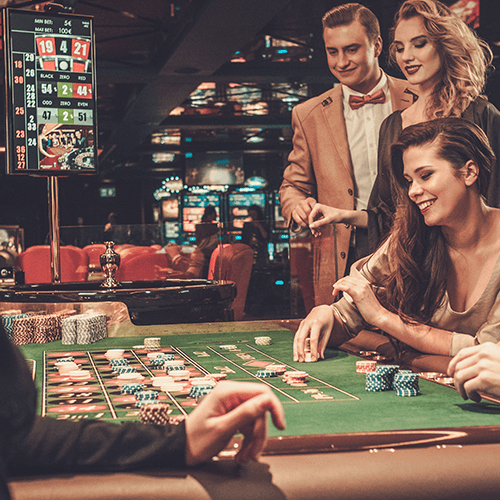Image of 3 people playing roulette in casino setting